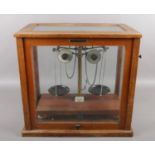 A cased set of Griffin & Tatlock chemical scales. Cased WJ George Ltd. Missing scale plates.