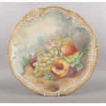 A late 19th century hand painted charger. Depicting still life fruit. Signed indistinct.