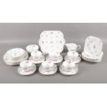 A Shelley teaset in the 'Charm' pattern. Comprising of six cups and saucers, six plates, six side