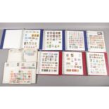 A box of albums containing world stamps. Including French, Denmark, Saudi Arabia, South African,