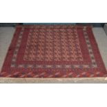 A large red ground Bokhara wool carpet. (360cm x 244cm)