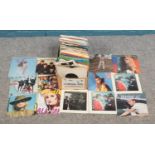 A large collection of singles records from various genres, including singles from The Beatles,