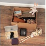 A box of miscellaneous. Includes Bergdorf Goodman dressing table set, Venetian masks, Harris Tweed