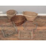 Three wicker baskets along with a quantity of metal baskets.