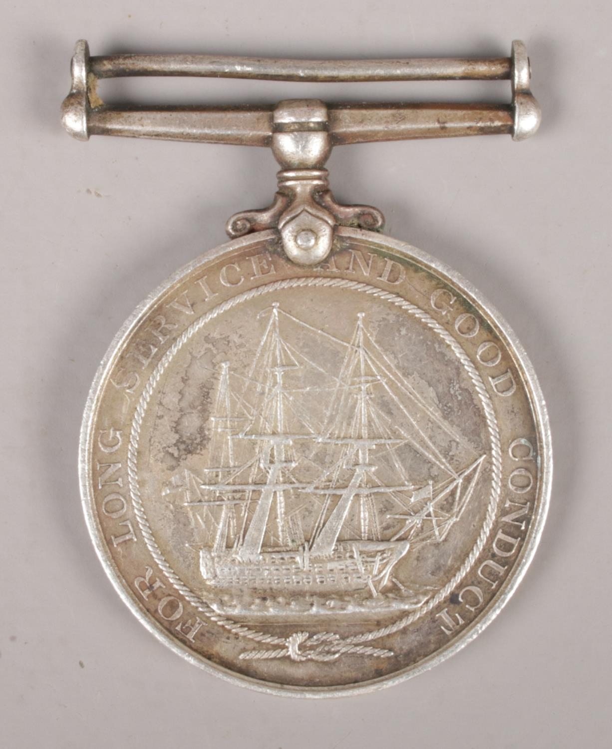 A George V Royal Navy long service medal, presented to T.H. Bray, HMS Bridgewater.