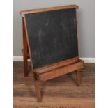 A vintage school folding chalk board. One sided heavily painted.