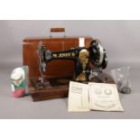 A cased Cylinder Shuttle Jones sewing machine. Comes with original oil bottle, nozzle and