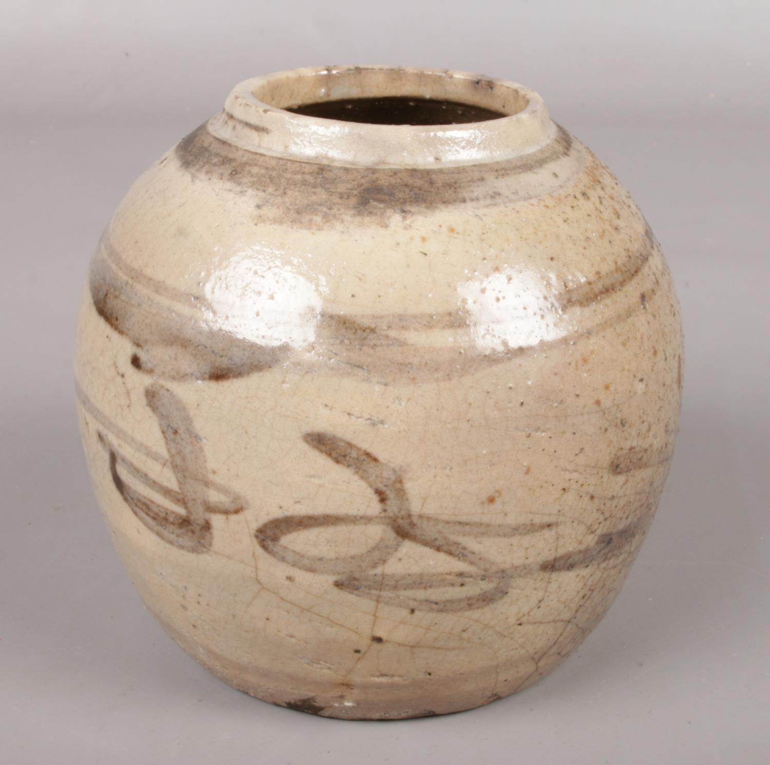 An antique Chinese stoneware ginger jar. Height 13cm.