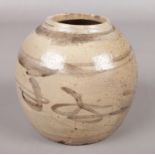 An antique Chinese stoneware ginger jar. Height 13cm.
