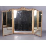 An antique gilt framed triple dressing mirror with swag pediment. Damage beneath mirror glass.