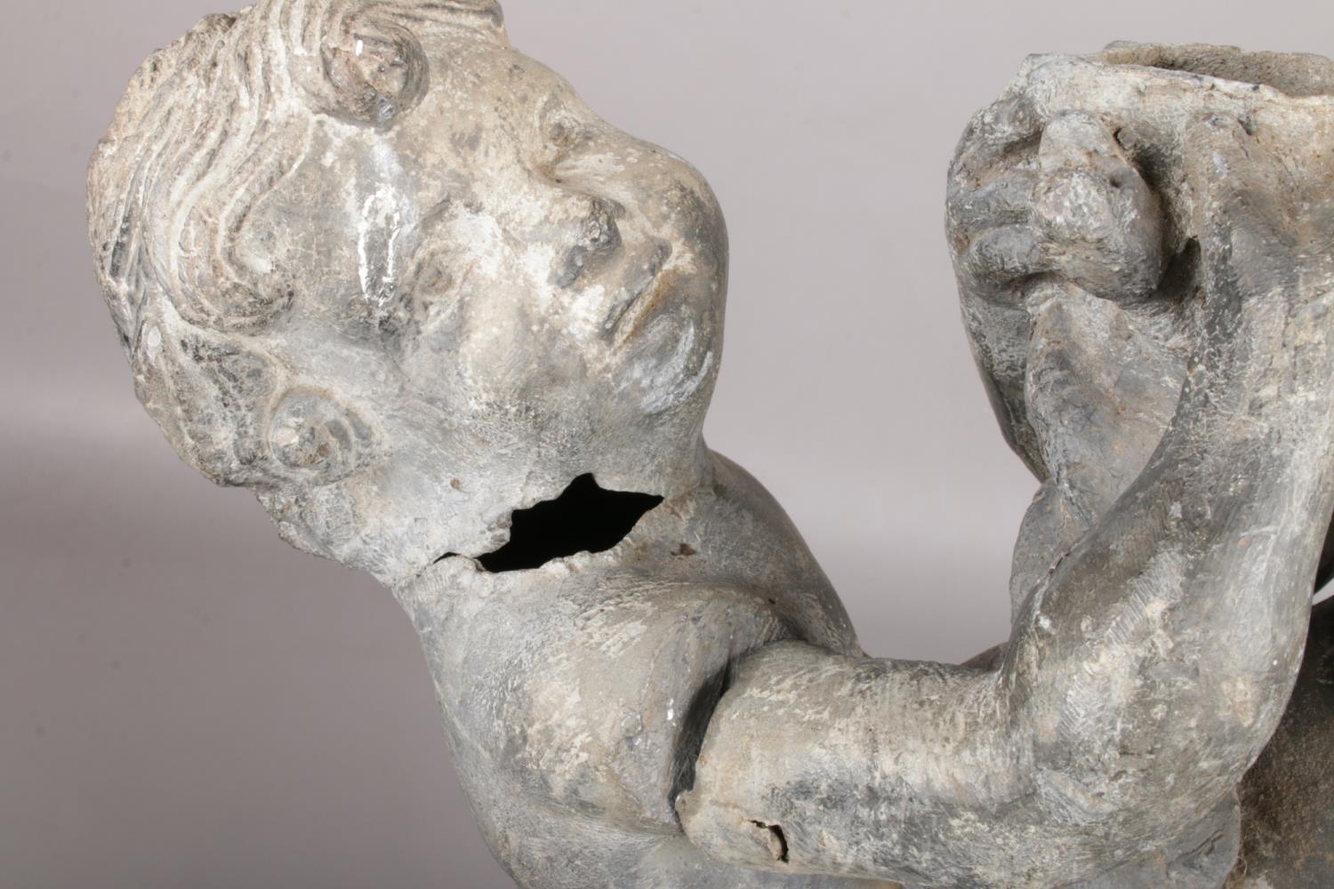 An antique garden statue pair of lead figures on base, clutching a twisted vine. Vine detached, - Image 3 of 4