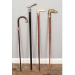 Four walking sticks, to include bone handled, jaguar car mascot and yellow metal collar (stamped J.