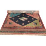 A multicoloured ground Turkish rug with geometric design. (310cm x 200cm)