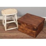 A white painted turned stool along with a wooden storage box.