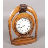 A Victorian clock movement in oak horseshoe stand.