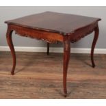 A French carved mahogany table, with cabriole legs. Height: 78cm, Width and Depth: 94cm.