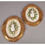 A pair of framed Capodimonte floral plaques.
