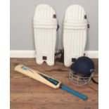 A Readers cricket helmet, bat and pads.