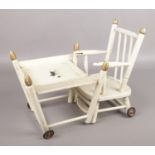 A white painted metamorphic doll's highchair and table, depicting a black Westie.