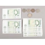 A selection of fourteen Bank of England £1 notes and and two shilling coins from 1948. To include