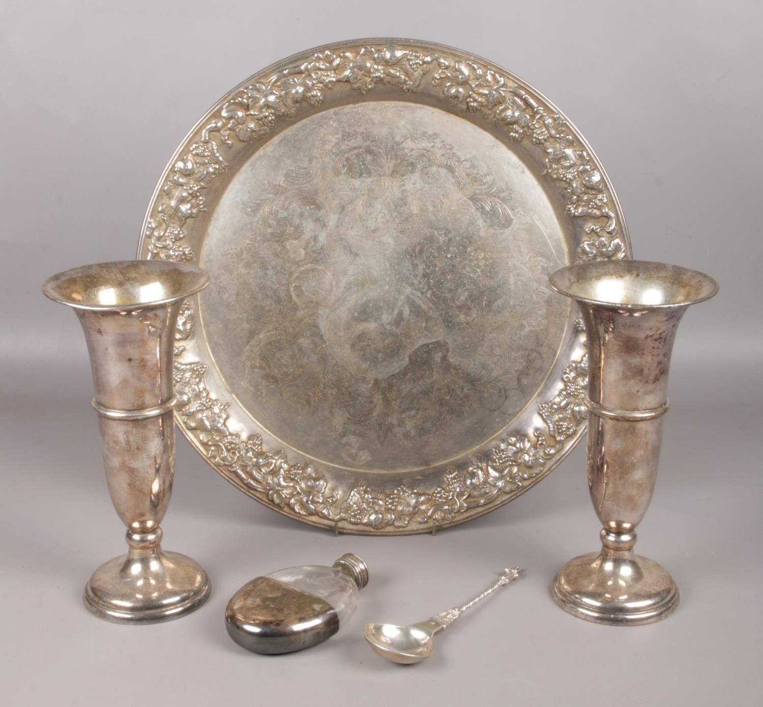 A small collection of white metal and silver plated items. To include a charger decorated with