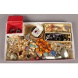 A tray of costume jewellery. Includes vintage brooches, stewards badges, beads etc.