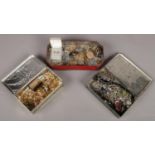 Three tins with contents of costume jewellery. Includes snuff box, gilt jewellery, vintage