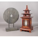 A wooden oriental temple table light with wooden circular sculpture. Lamp H:47cm W: 20cm. Light in