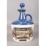 A Lamb's Navy Rum flagon 750ml (40% Vol). Decorated with HMS Warrior. Sealed. H: 21cm.