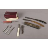 An assortment of pen knives and razors. To include two Kropp cut throat razors (one boxed), three