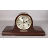 A mahogany dome shaped presentation mantel clock.