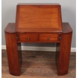 An Art Deco mahogany bureau. Flanked by two open bookcases. One side loose.
