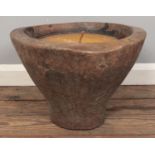A large citronella candle, mounted within a large carved hardwood stand. Height: 31cm, Diameter: