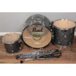 A Remo Pearl 3 piece drum kit with stands.