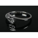 A 14ct white gold ring, tension set with two colourless stones. Size N 1/2. 2.3g.