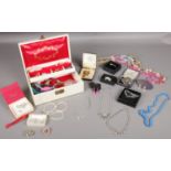 A quantity of costume jewellery. Brooches, necklaces, beads etc to include a jewellery box.