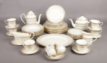 A fifty-two piece Minton dinner service in the 'Marquesa' design. Includes Tea and Coffee pots,