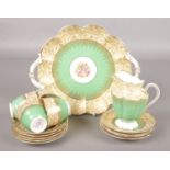 A collection of George Jones Crescent bone china with green and gilt borders and floral central