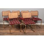 A set of six Marcel Breuer style Cesca chairs with brass coloured tubular frame and maroon striped