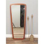 A vintage wall mirror along with a brass poker & shovel.