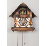 A West German cuckoo clock. Comes with weights and wooden pendulum. Reportedly plays 'The Blue