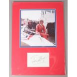 A mounted photograph and autograph of British Formula One driver James Hunt. Height: 42cm, Width: