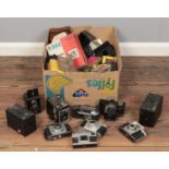 A box of camera equipment. Including box cameras, Kodak, Ilford, flashes, Agfa, etc.