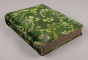 A velvet covered photograph album, with anchor and mirror to the rear.