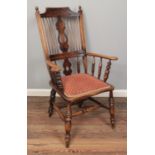 An ash/elm Windsor armchair, with pierced splat and reeded back, turned base and pad arms. Raised on