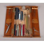 An oak pipe display case with an assortment of collectables. To include a selection of paper mate