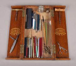 An oak pipe display case with an assortment of collectables. To include a selection of paper mate