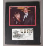 A mounted photograph and first day cover signed by Horror actor Christopher Lee, and others.