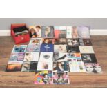 A collection of fifty six vinyl single records, mostly from the 80's. To include artists such as