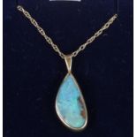 A silver gilt matrix opal pendant on 9ct gold chain.